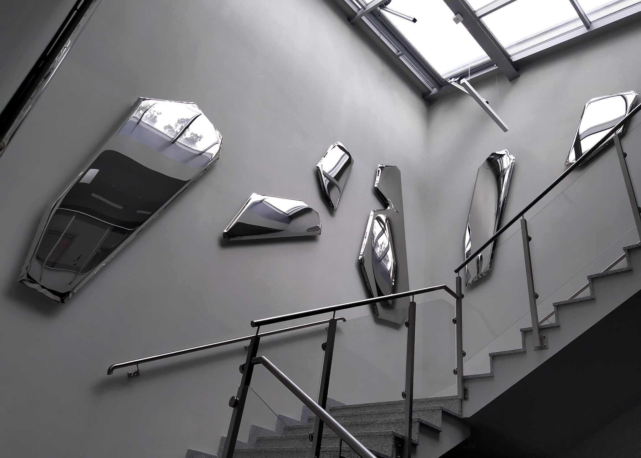 Eight mirrored steel panels exposed on the staircase of the Museum
