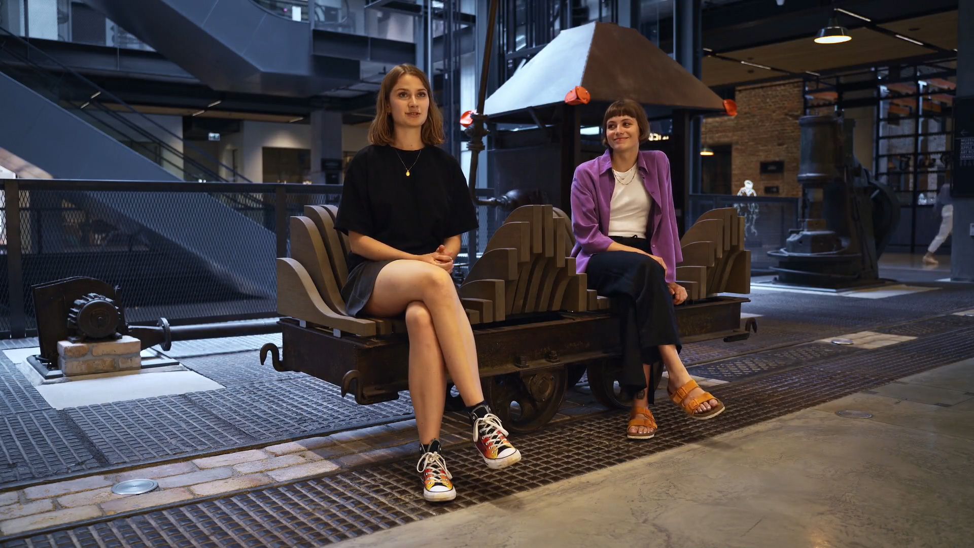 Klara Malinowska and Aleksandra Szawdzin, students of the School of Form, on the bench they designed at the Norblin Factory | Screenshot from a video produced by Mediafresh for the Norblin Factory