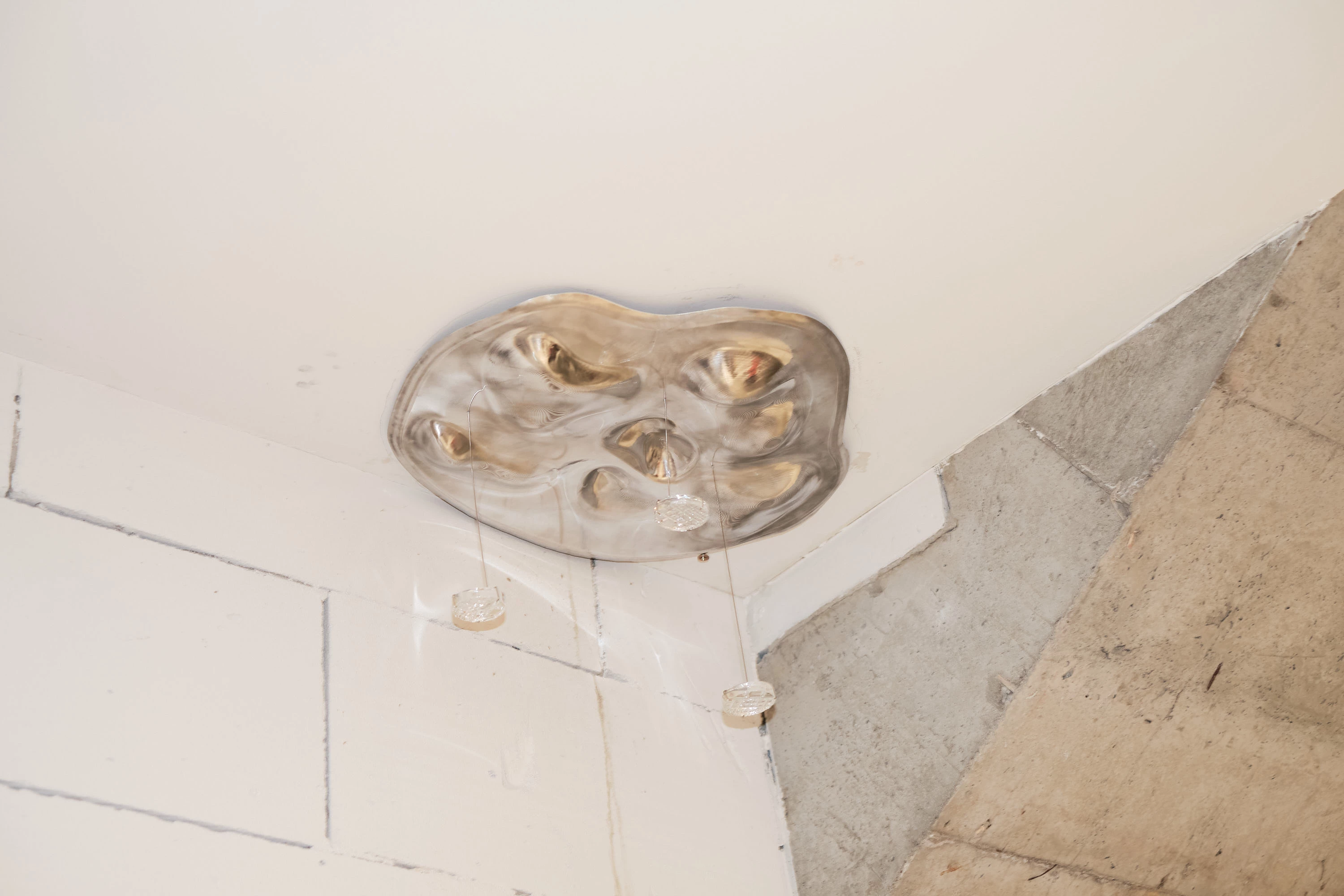 Irregular shaped metal plate glued to ceiling