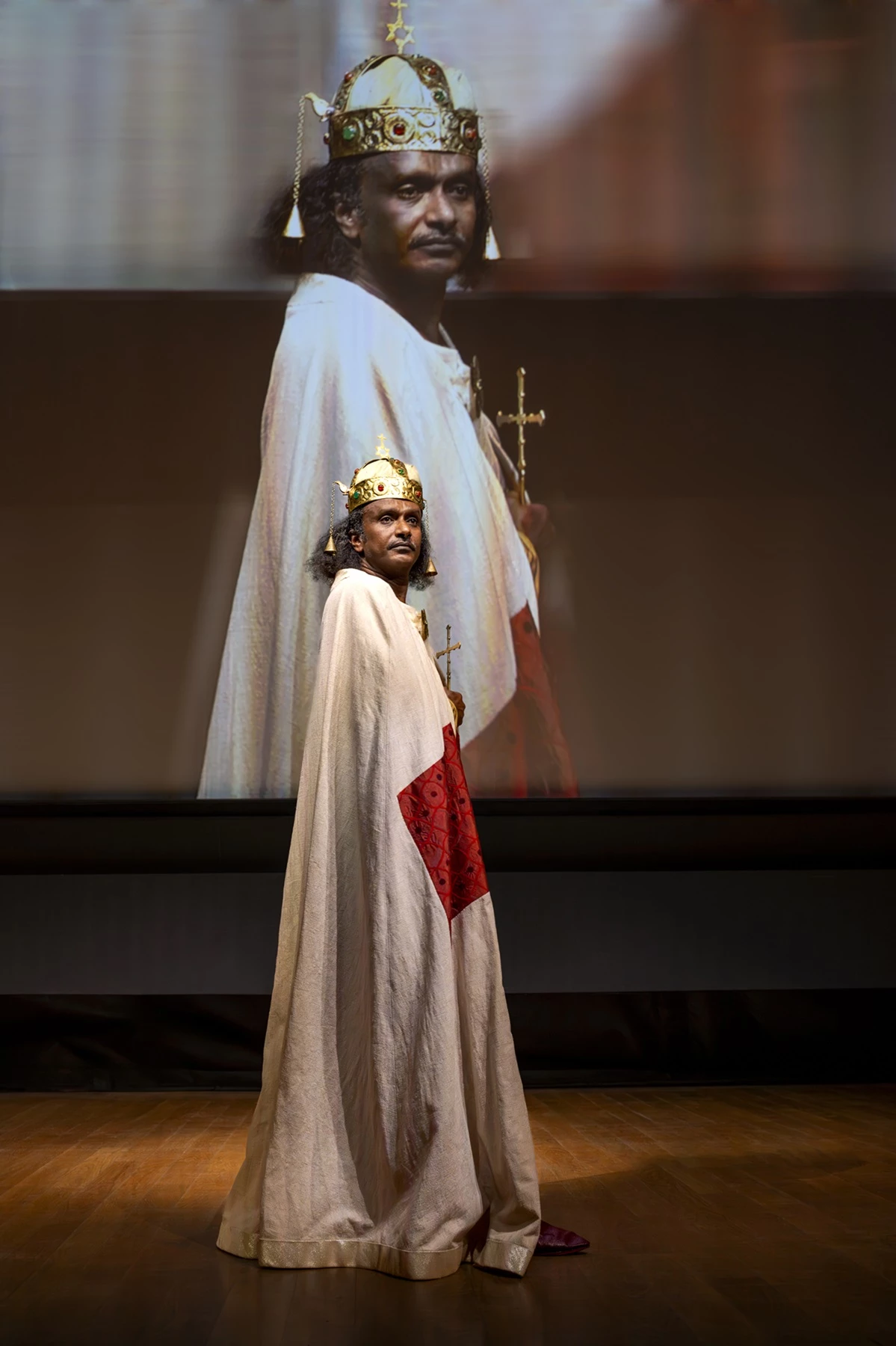 A photo of a model wearing a reconstructed royal costume from Faras, captured during a presentation in Paris.
