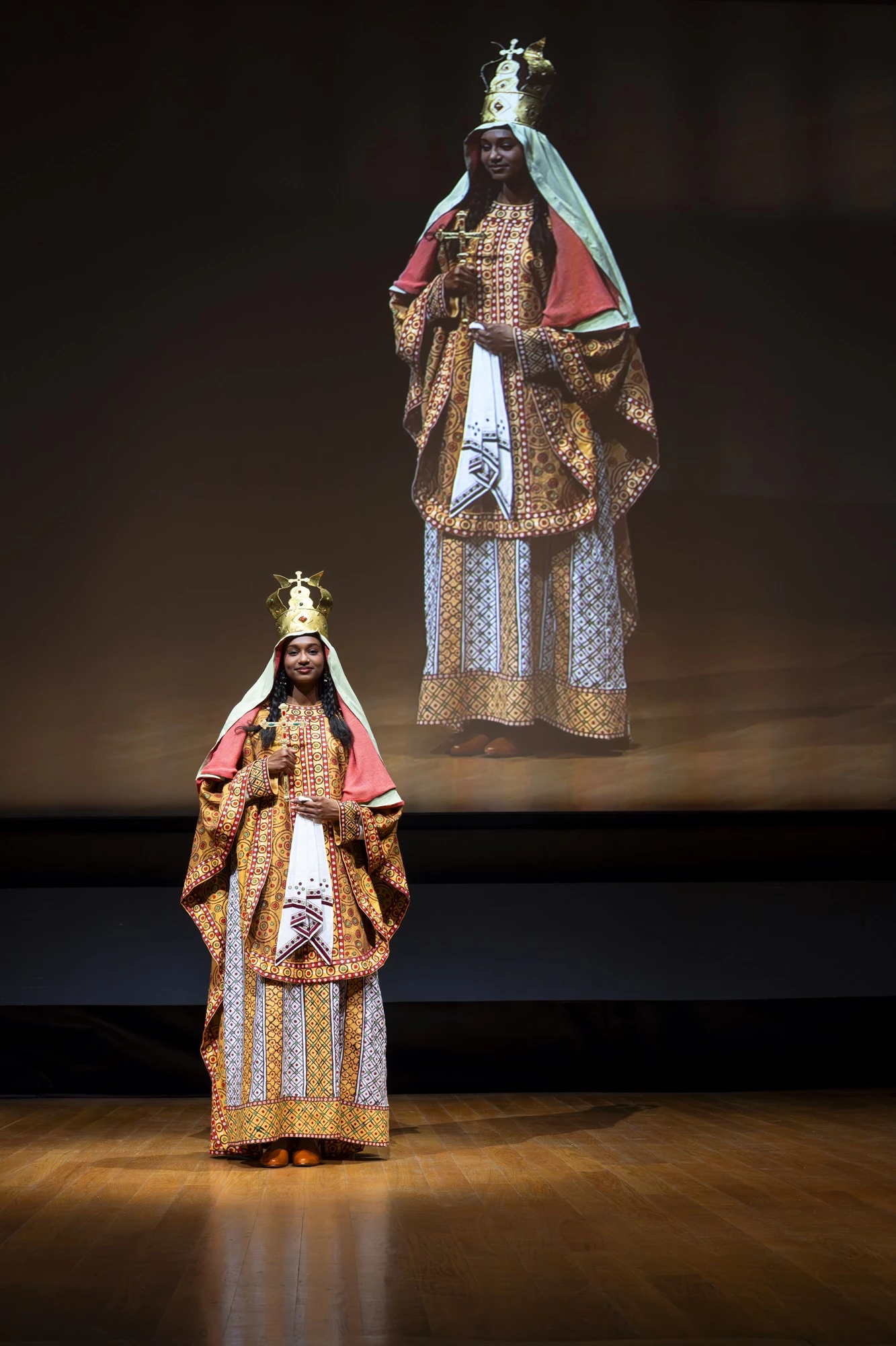 A photo of a model wearing a reconstructed royal costume from Faras, captured during a presentation in Paris.