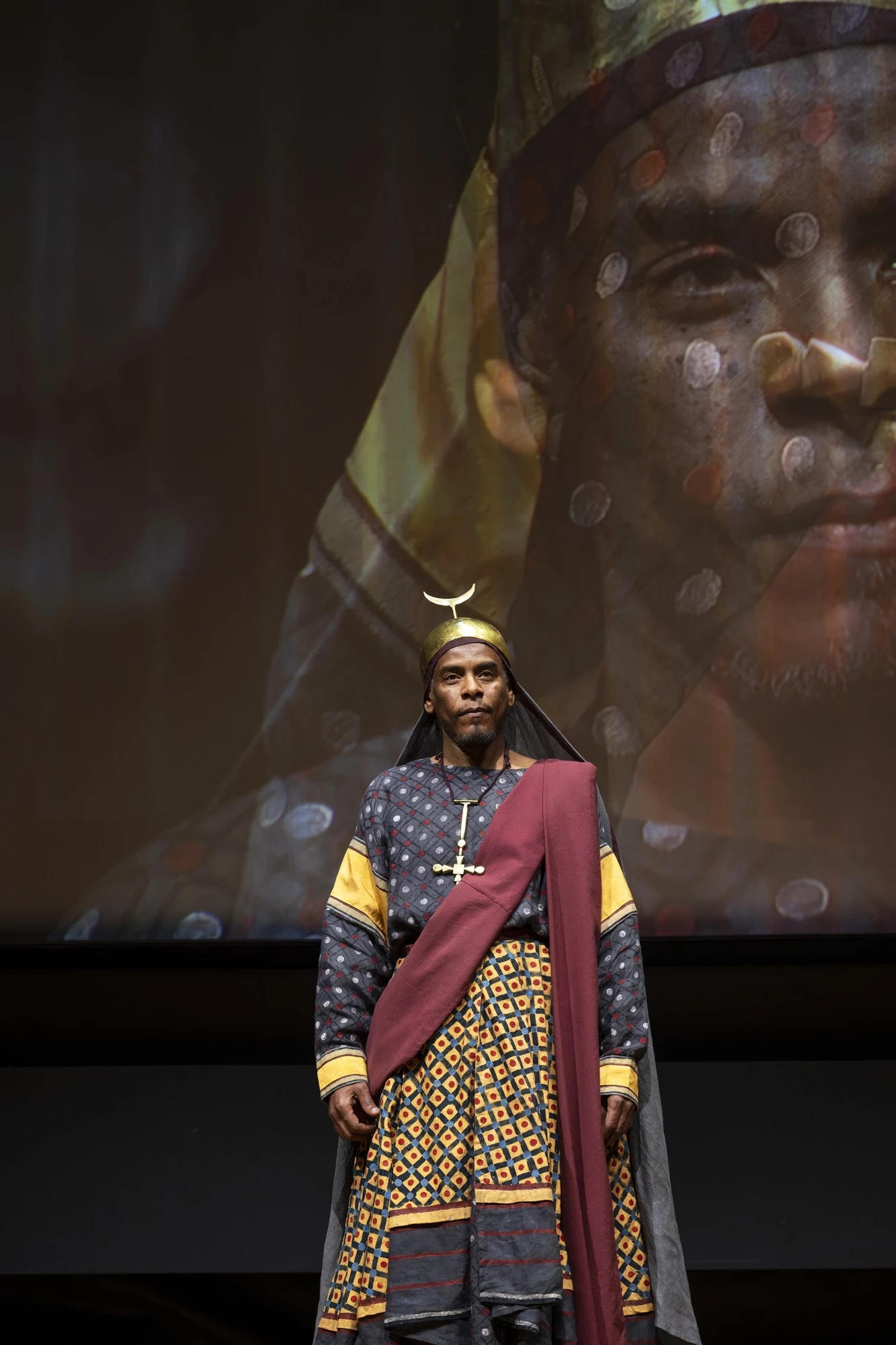A photo of a model wearing a reconstructed royal costume from Faras, captured during a presentation in Paris.
