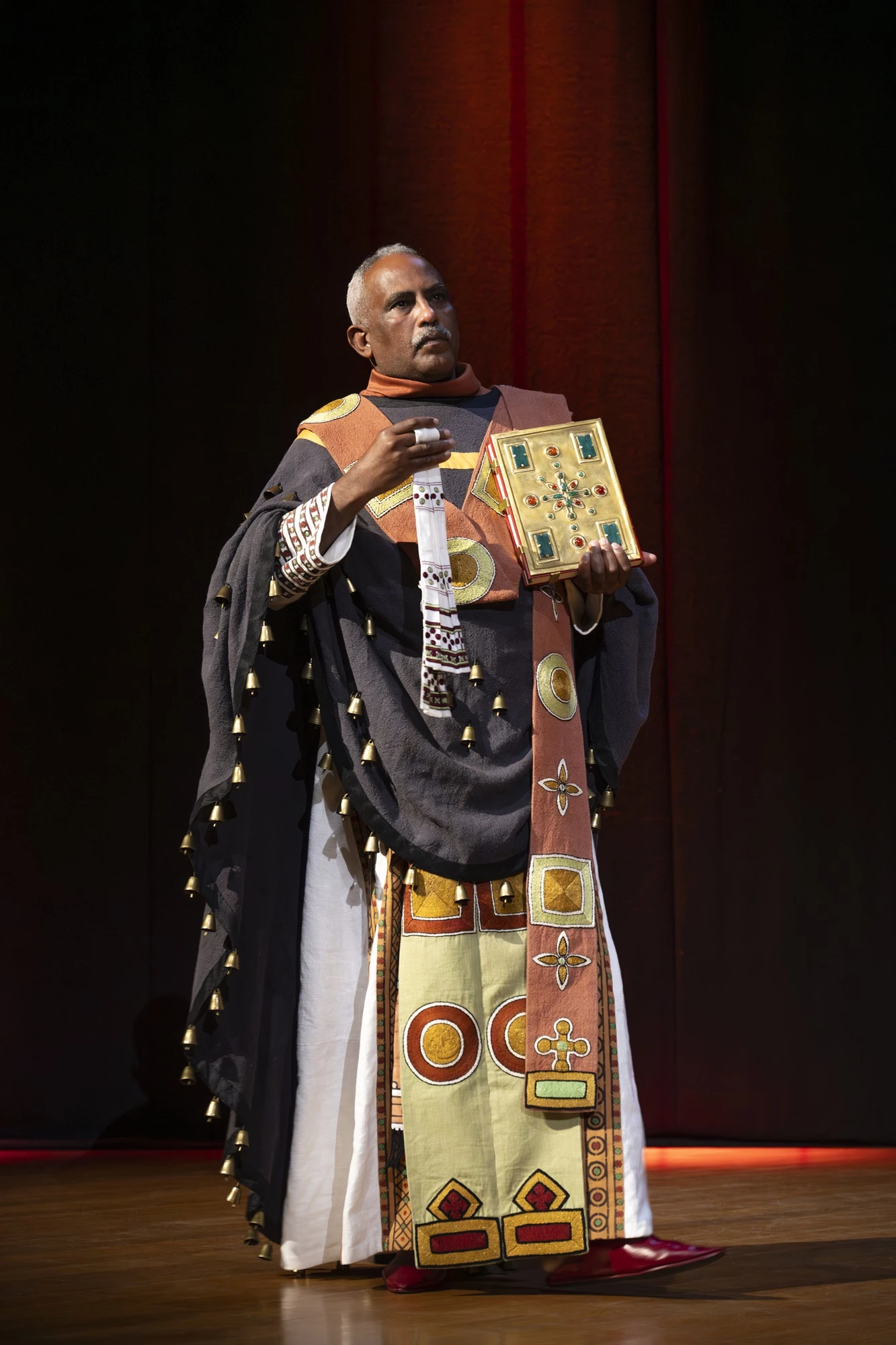 A photo of a model wearing a reconstructed royal costume from Faras, captured during a presentation in Paris.