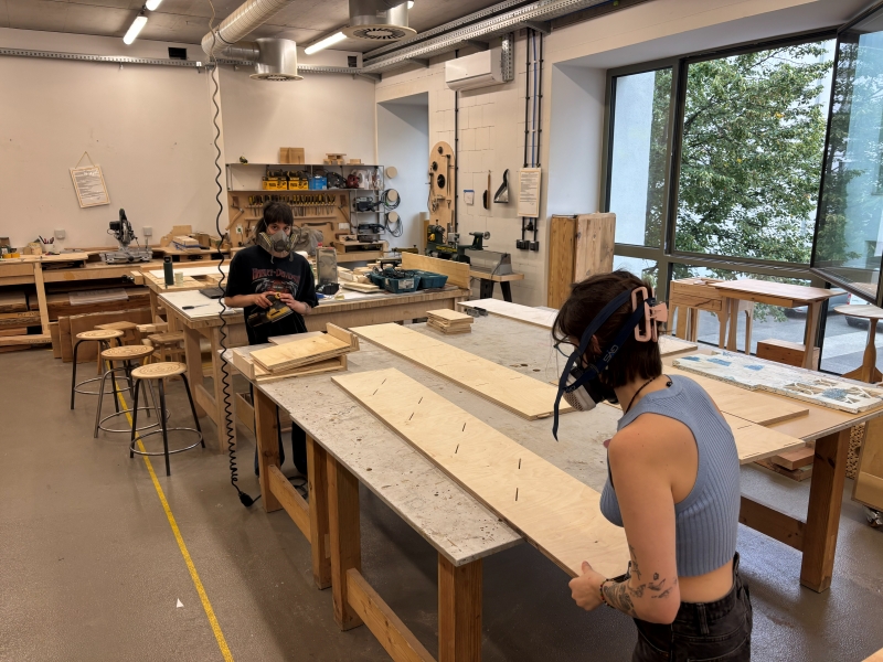 Two students working in the School of Form woodworking workshop.