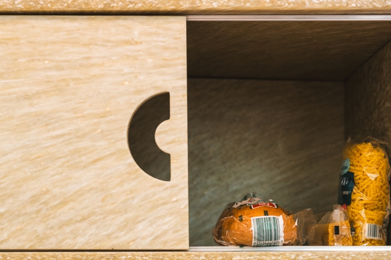 Close-up of a shelf in the SWPS University food sharing corner with food items.