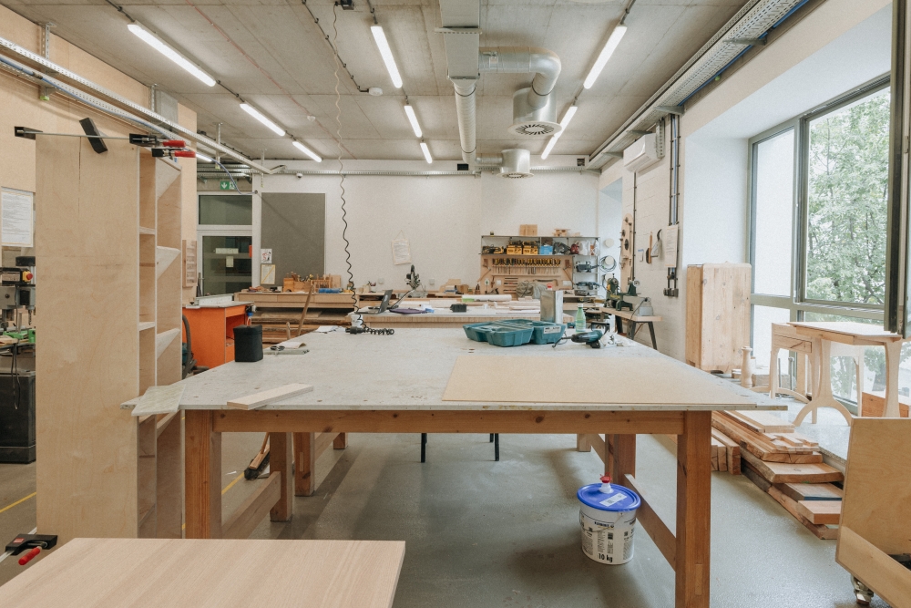 Interior of the woodworking workshop, showing a large worktable.