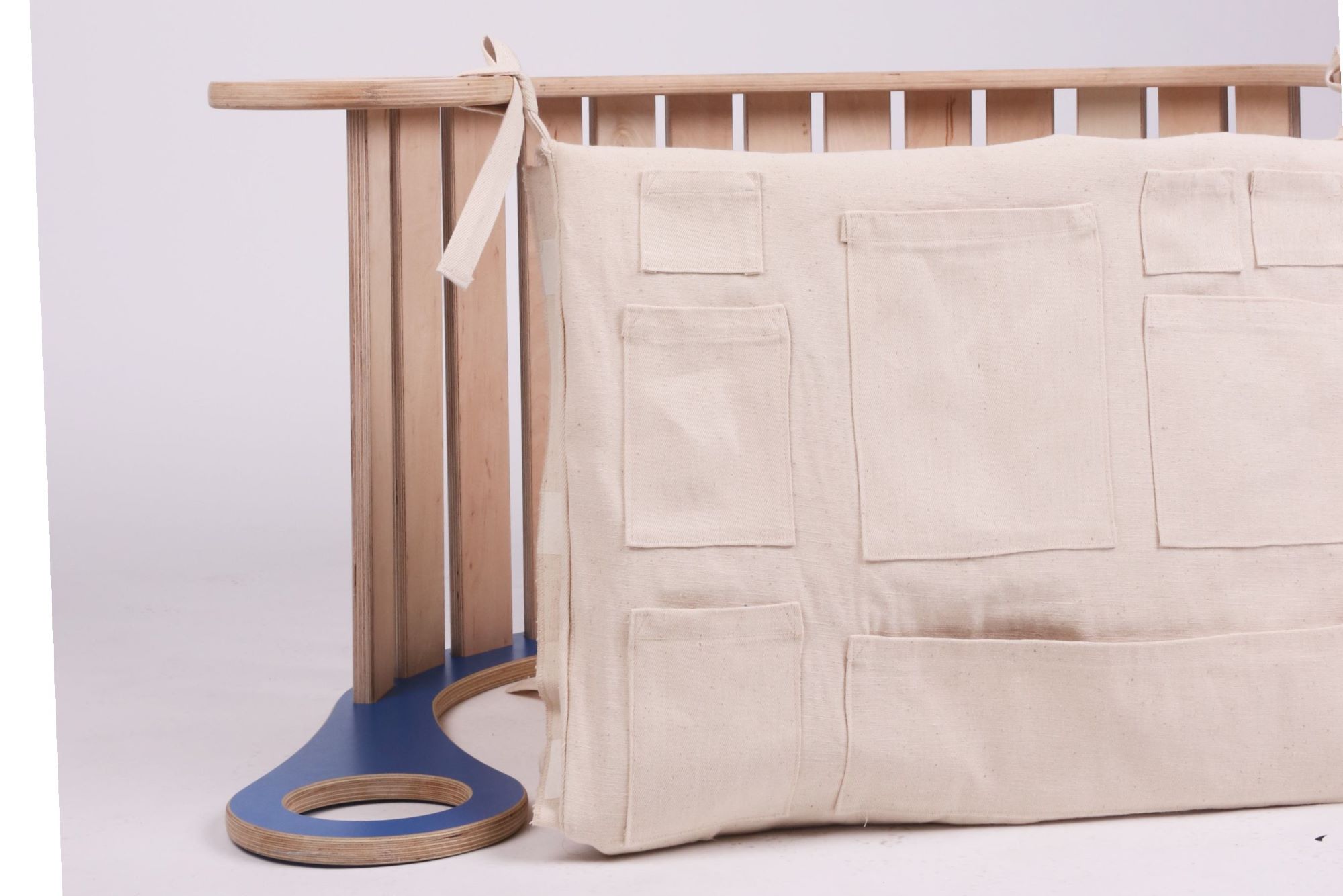 Rocker with a fabric cover featuring pockets for toys