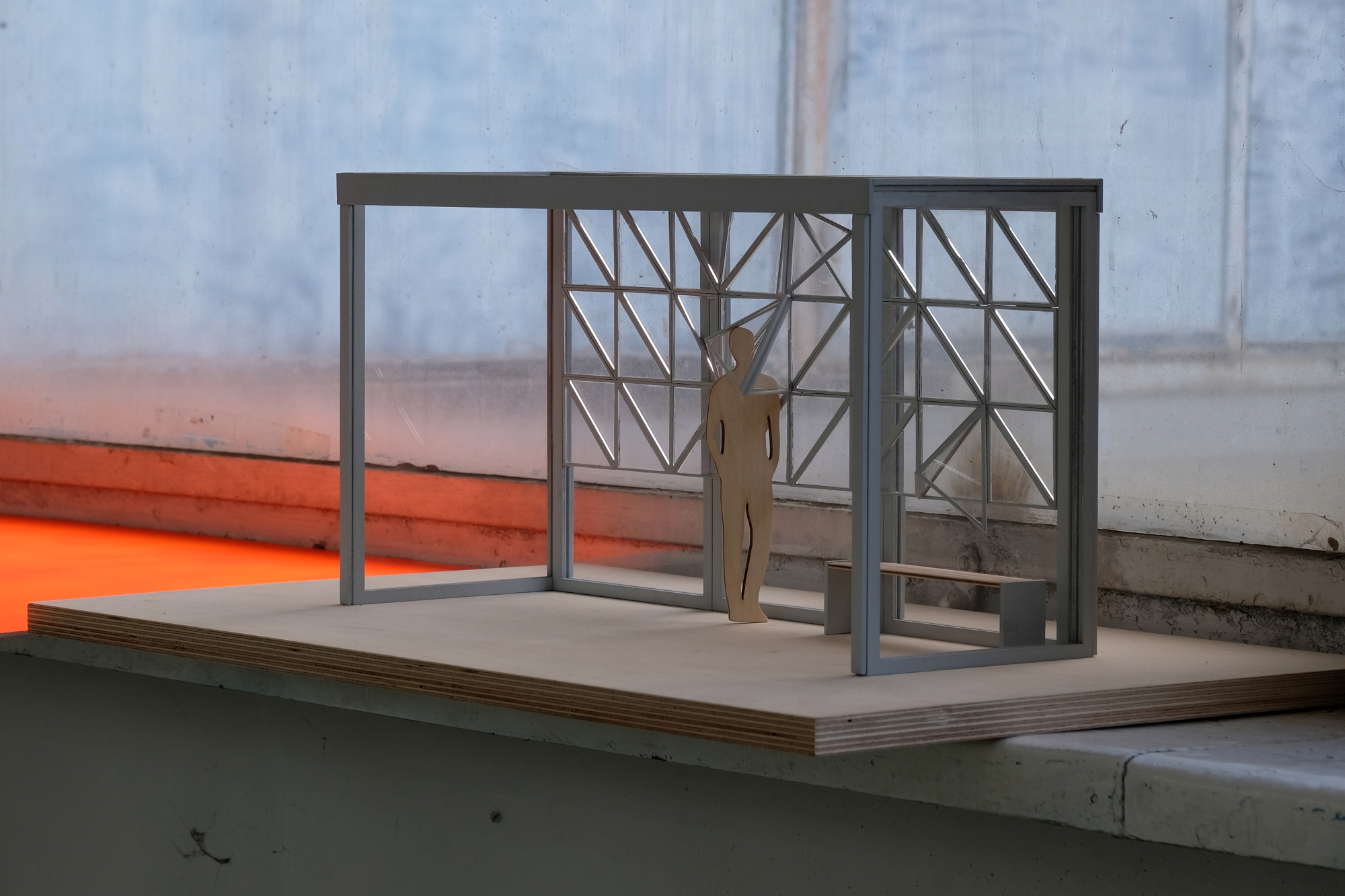 The bus shelter model designed by Maja Marlicz is displayed on a window sill.