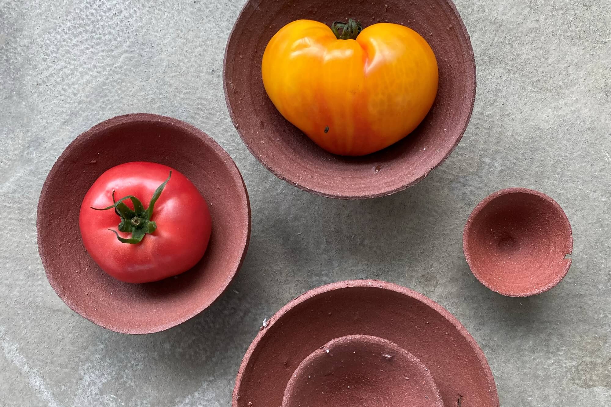 Clay pots designed by Wit Bojar; two of them contain tomatoes