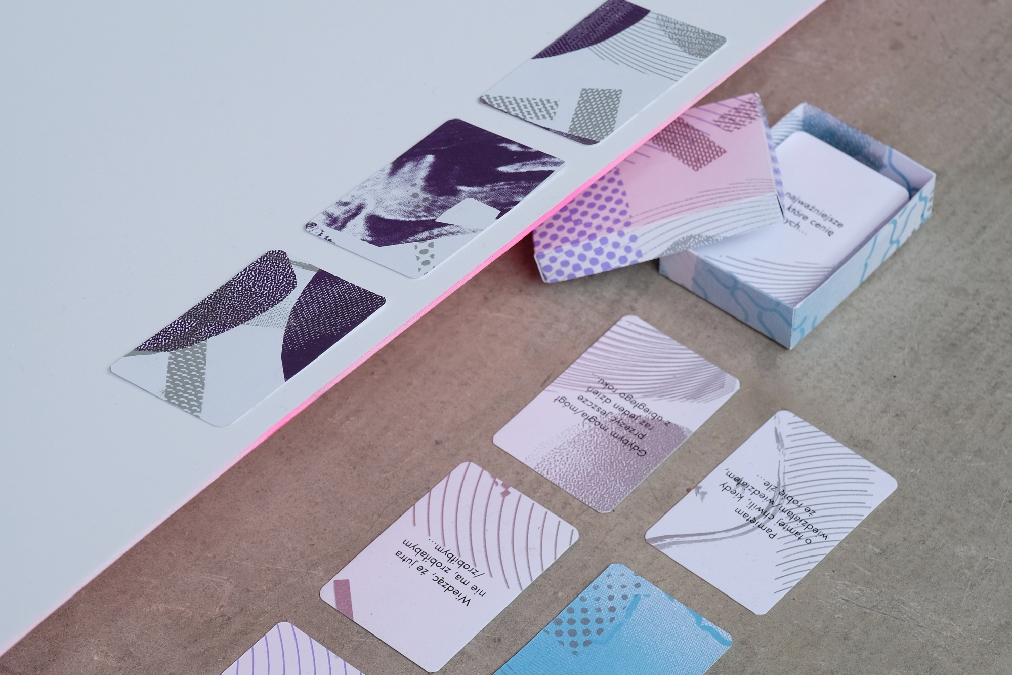 Deck of cards designed by Jakub Zyśko placed on a concrete floor