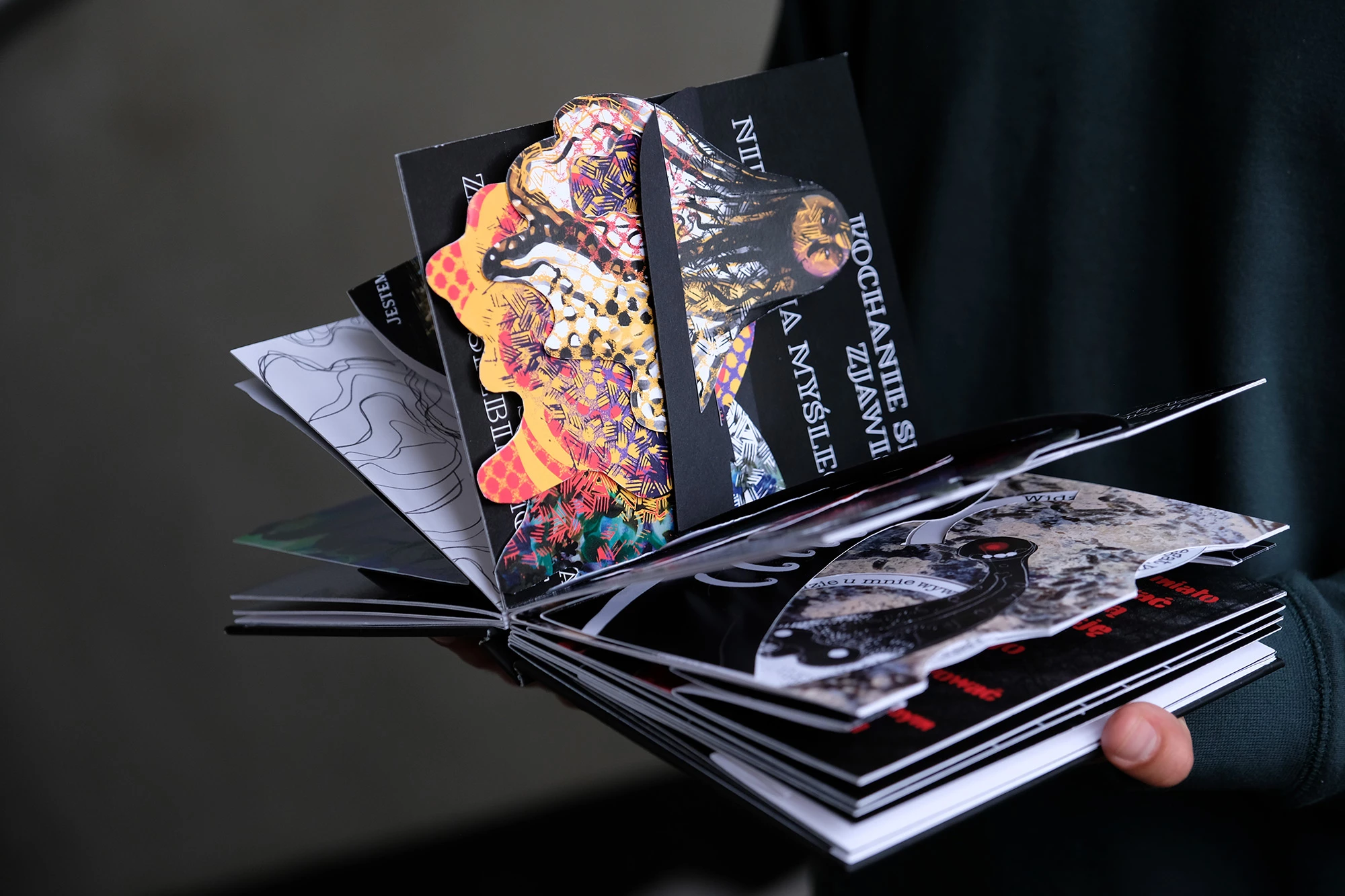 Open book with colorful illustrations inside, including 3D illustrations