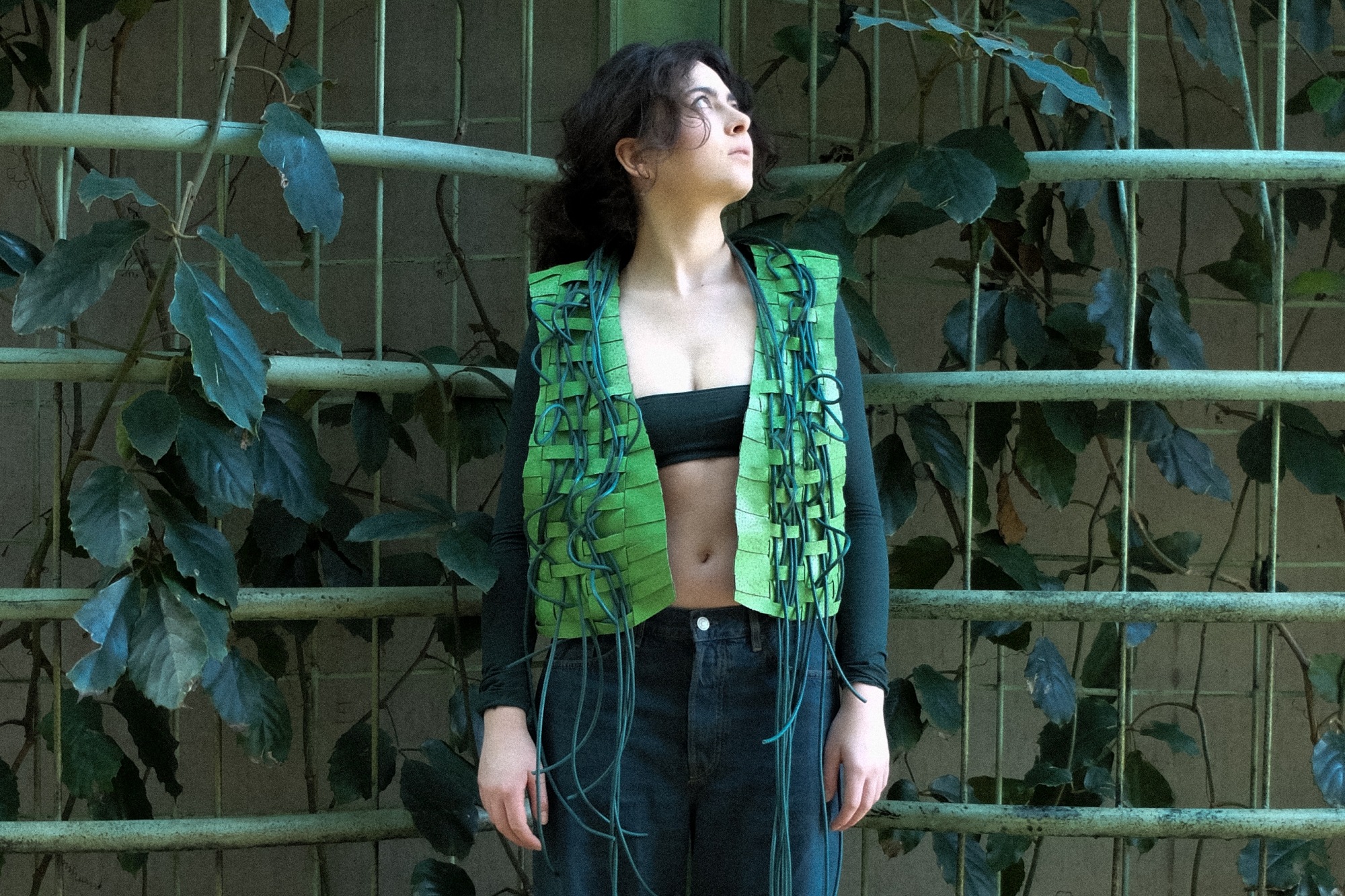 Model wearing a vest made of roofing membrane and PVC cord.