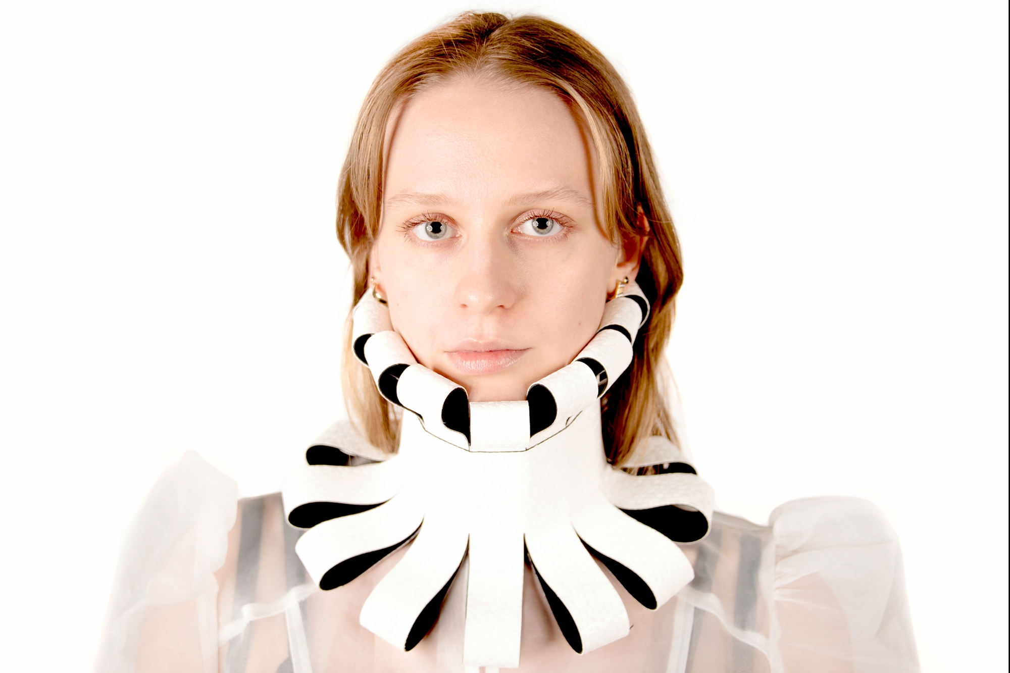 Model wearing a victorian-style collar made of roofing membrane