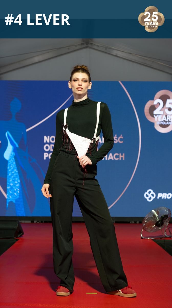 Fashion show: model wearing a handbag made of roofing membrane.