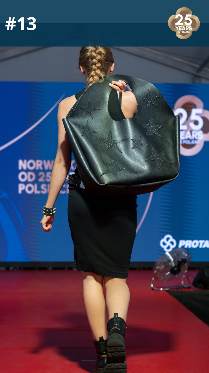 Fashion show: model wearing a handbag made of roofing membrane.