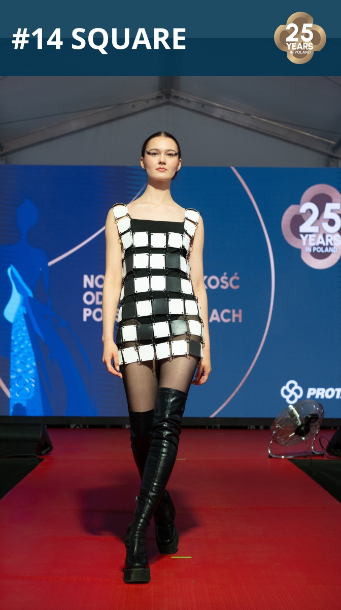 Fashion show: model wearing a dress made of roofing membrane.